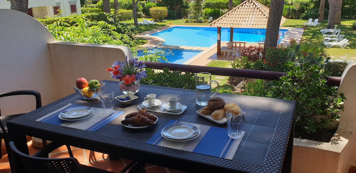 Private terrace at a Vilamoura golf apartment overlooking Solar do Golf pools and gardens.