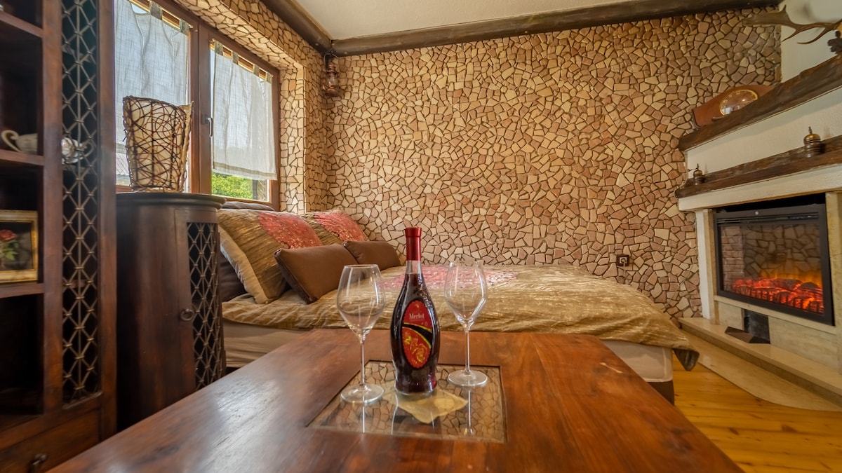 Всекидневна с електрическа камина и разтегателен диван.