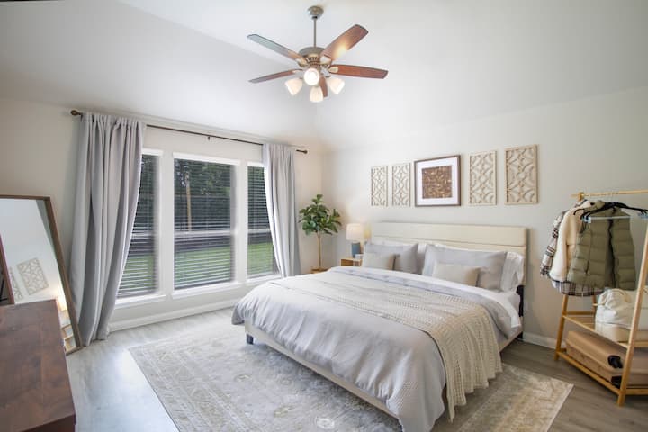 The primary bedroom is furnished with king sized memory Novafoam bed, has blackout curtains, and a white noise player for a peaceful nights sleep on Lake Conroe or after teeing off at Walden Golf Course