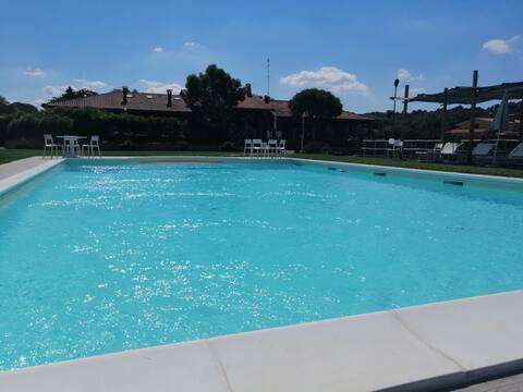 Villa surrounded by greenery with pool, tennis and soccer
