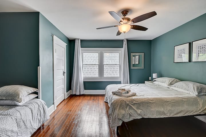 Upstairs primary with a queen and twin bed