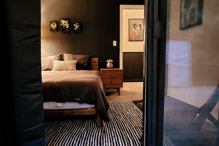 View of Bedroom 2 from Lower Deck

-Dresser
-2 nightstands with USB and/or outlets nearby
-Sitting Chair
-Blackout Curtains
-View to the lower deck surrounded by trees!