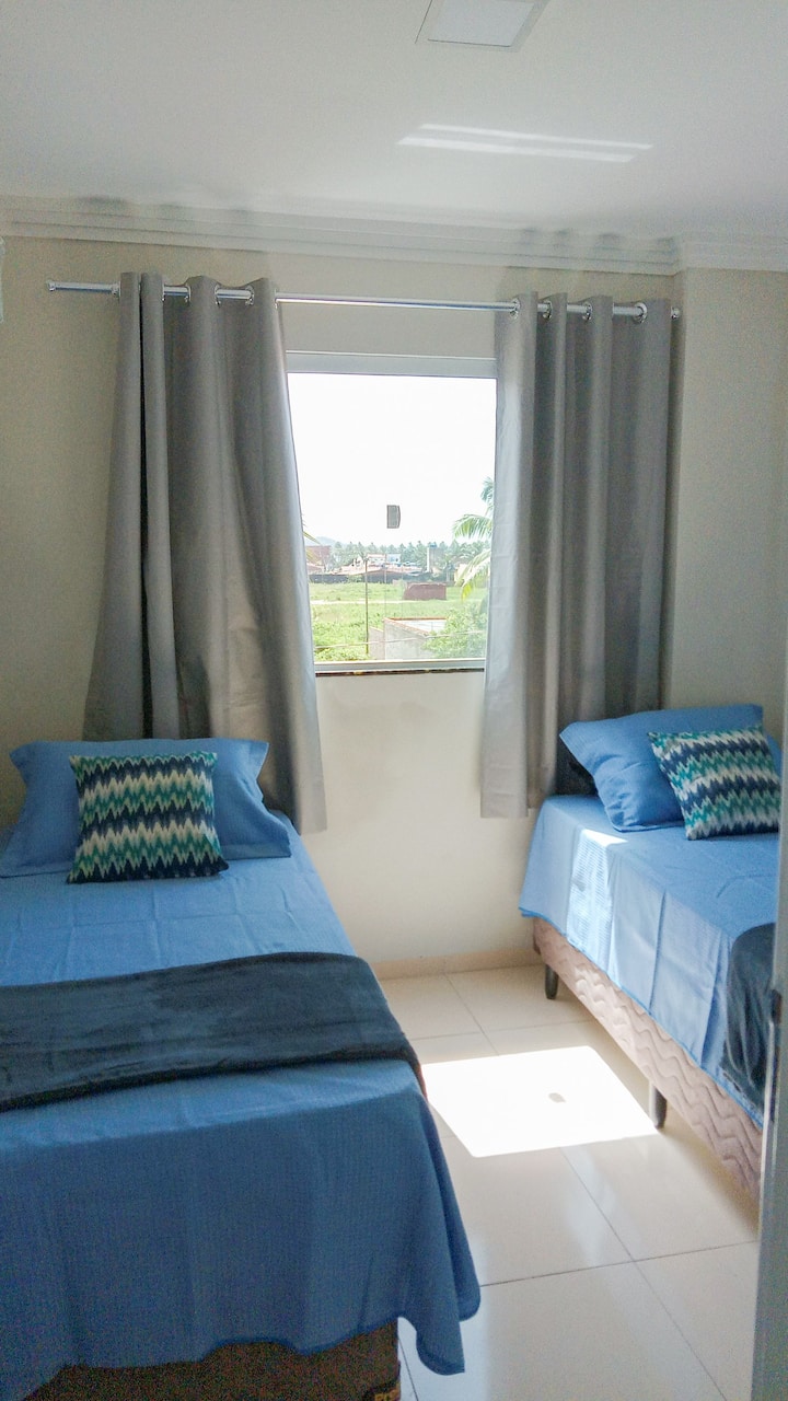 Room with two single box beds, blackout curtain and air-conditioning.