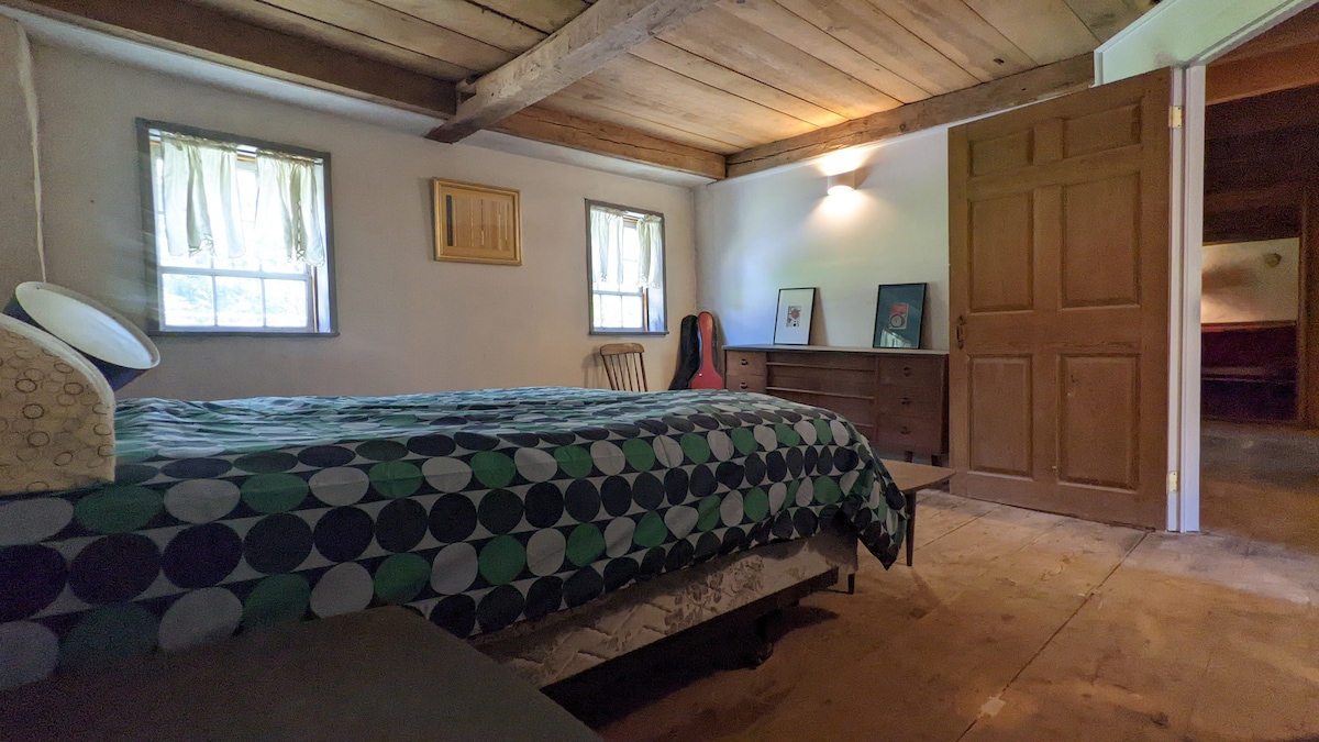 Bedroom #2 has a queen-size bed, nightstands, a dresser, and a chair. 