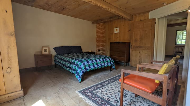 Bedroom #1 has a queen-size bed, two chairs, a writing desk, a nightstand, and a dresser. This room has beautiful morning light. 