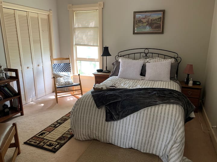 The secondary bedroom has a full bed and a view of the Helena Cathedral