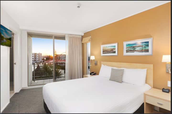 Master Bedroom with Balcony over Pool and looking across to the main shopping area in Ballina