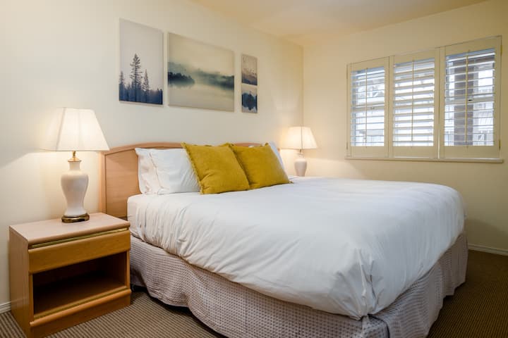 The bedroom has a King-size bed. The window looks into the swimming pool through the balcony, which is a quieter side of this building.