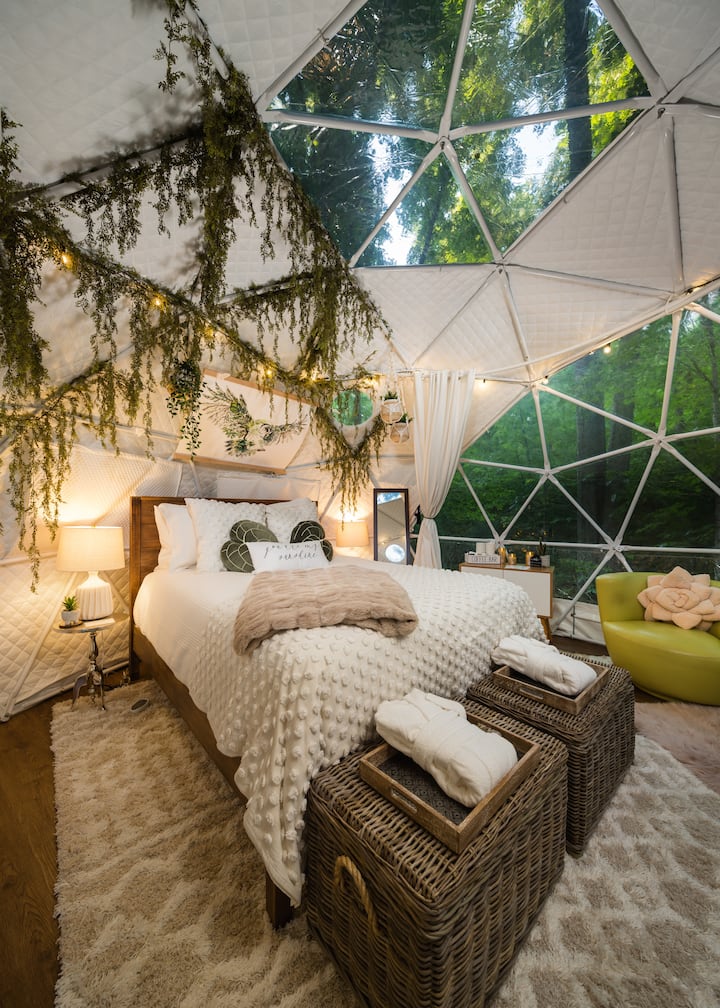 Bedroom - queen size bed with plush bedding and optional mattress heater. Lounge area and coffee bar to the side. Large panoramic window and sky light for nature views and natural light.