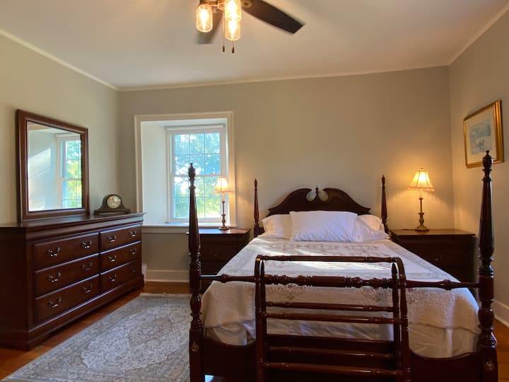 Spacio2nd floor bedroom with queen bed & plenty of room to set up a queen air mattress. Room-darkening shades help you sleep in comfort, and the closet is stocked with extra sheets and a Pack ’n Play — perfect for families traveling with little ones.