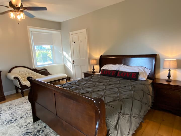 Spacious 2nd floor bedroom with a comfortable queen bed, conveniently located just off the bathroom. Plenty of room to add a queen air mattress for extra guests. Room-darkening shades help ensure a restful and peaceful sleep.