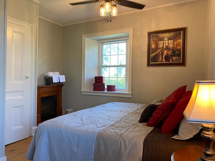 2nd floor bedroom with the option of a king bed or two twins, perfect for couples or friends traveling together. Enjoy cozy evenings by the electric fireplace and wake up to peaceful river views. Room-darkening shades ensure a restful night’s sleep.