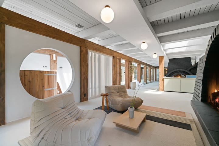 Positioned just in front of the fireplace is a specially curated sitting area, meticulously arranged for relaxation and comfort. The chairs are strategically placed to offer the perfect vantage point for basking in the soothing ambiance.