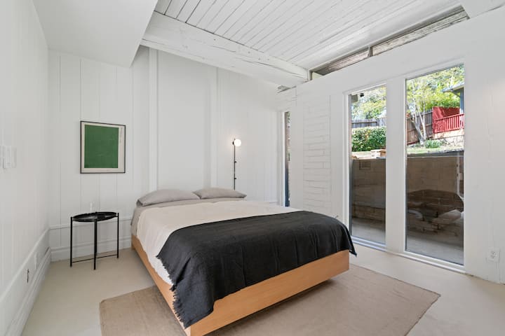 The white walls serve as a canvas, allowing the natural light to fill the space and create an airy and open feel. Sink into the plush bedding, where luxurious linens and fluffy pillows await. 