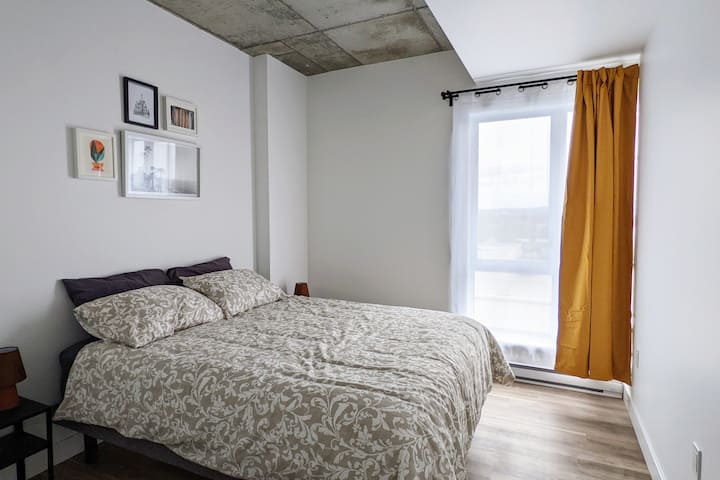 Bedroom with a queen-sized bed and a wardrobe