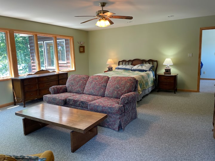 Master Guest Suite - Yes, that is your gorgeous lake view that you wake up to each day.  This extra large bedroom suite has a king bed.  Also a 2 person futon couch, and 2 bunk beds if needed.  Room has private full bath, shower and/or tub combo.