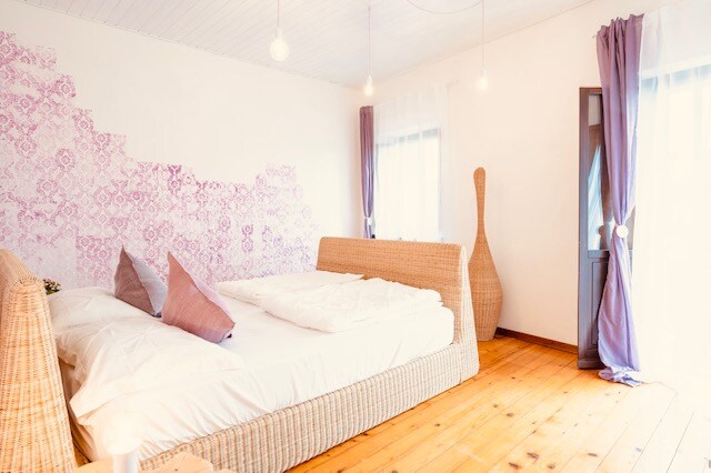 חדר שינה זוגי גדול עם מיטת שיש טבעית ורהיטי מעצבים.