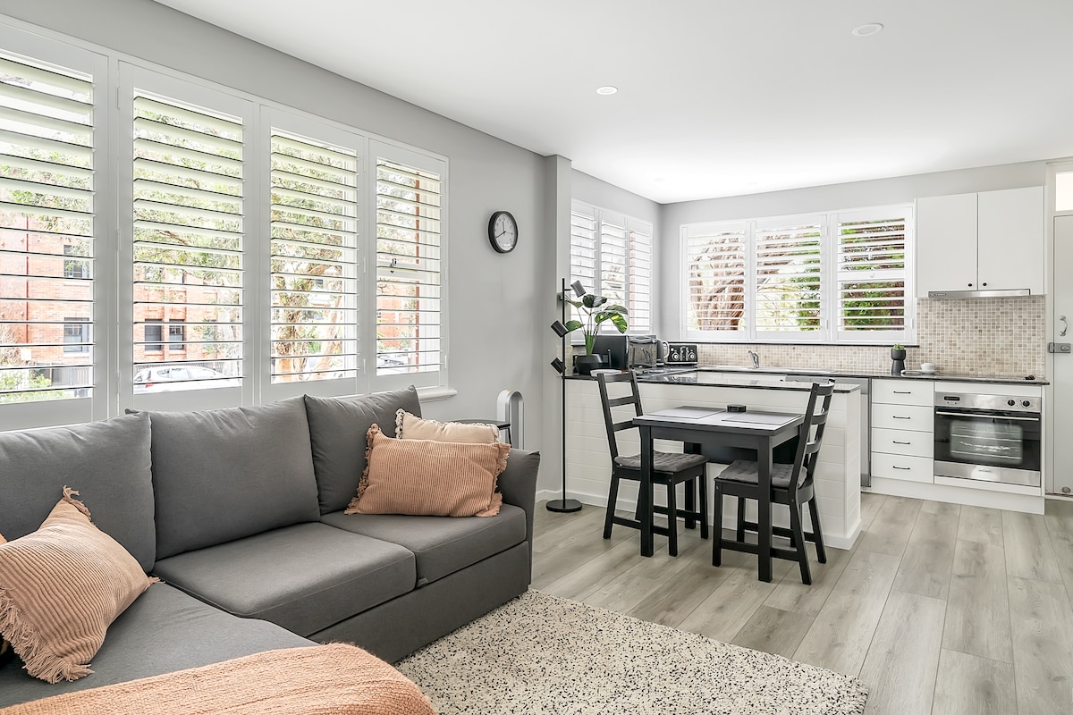 Living area, kitchen and dining with plenty of light and louvres for privacy.