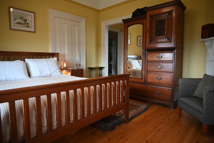 ห้องนอนหลักพร้อมเตียงขนาดควีนไซส์และห้องน้ำในตัว
