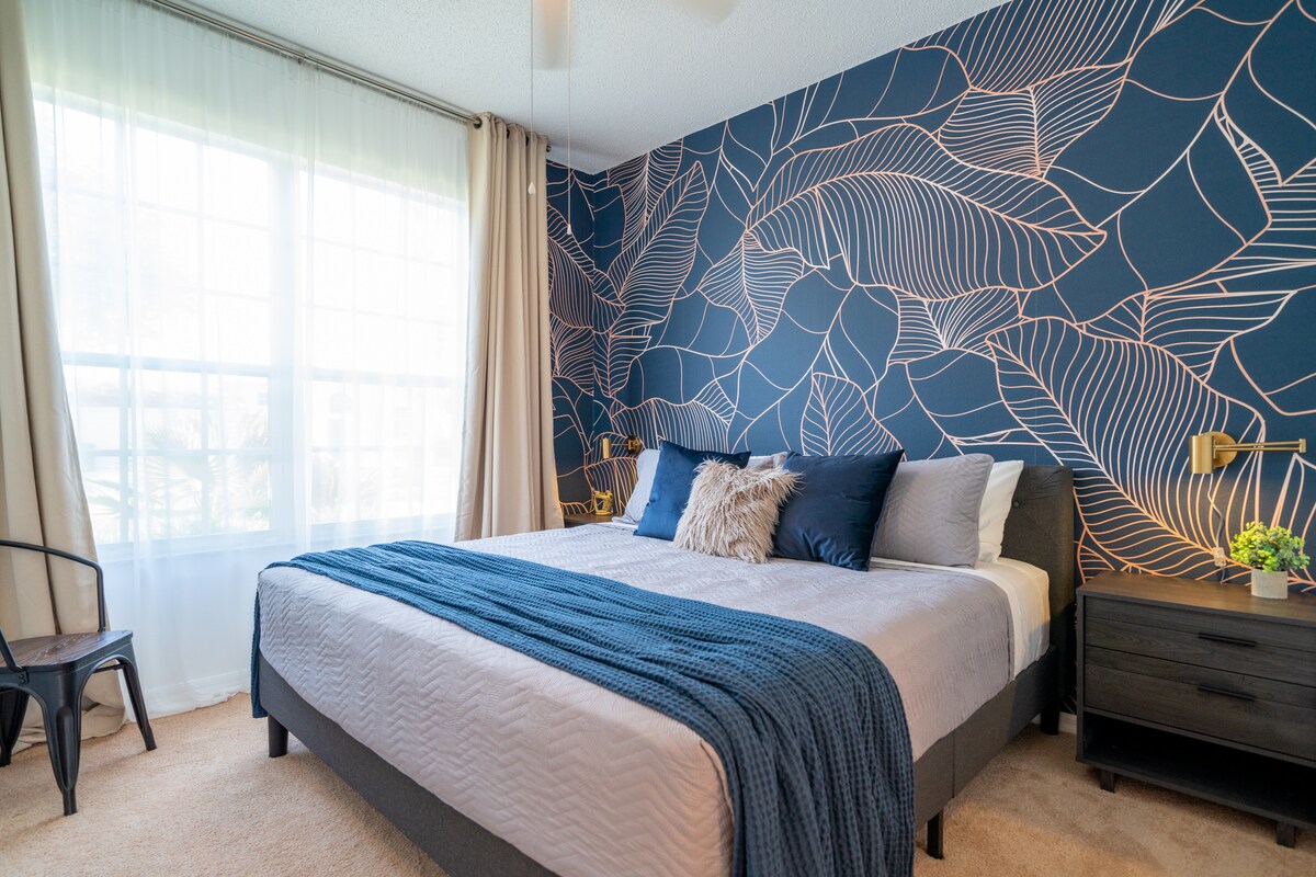 Bedroom 1 with king-sized bed, en-suite bathroom at TV with Disney+.