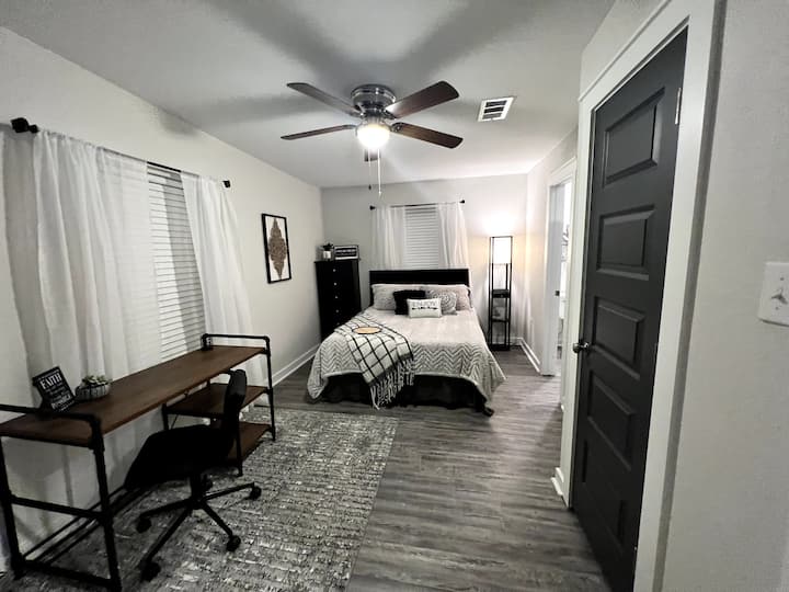 Bedroom 2: Queen bed, en-suite restroom, private work space, smart TV, closet and dresser for your items. 