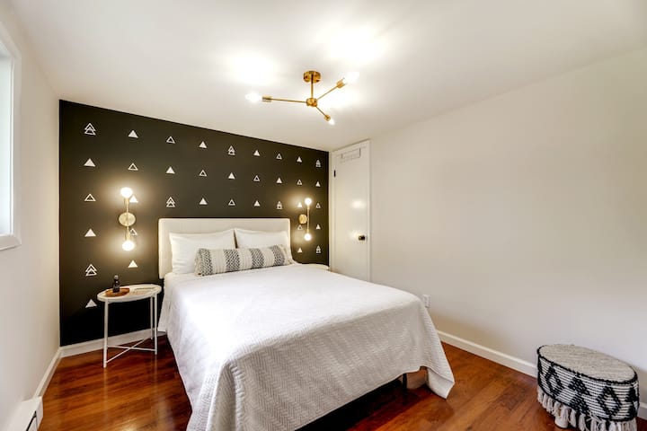 Take your pick of where to sleep… do you choose this boho-chic black and brass bedroom?  It boasts a full bed and a dedicated work desk (not pictured).  The closet comes with hangers and drawers to unpack your stuff and stay awhile.