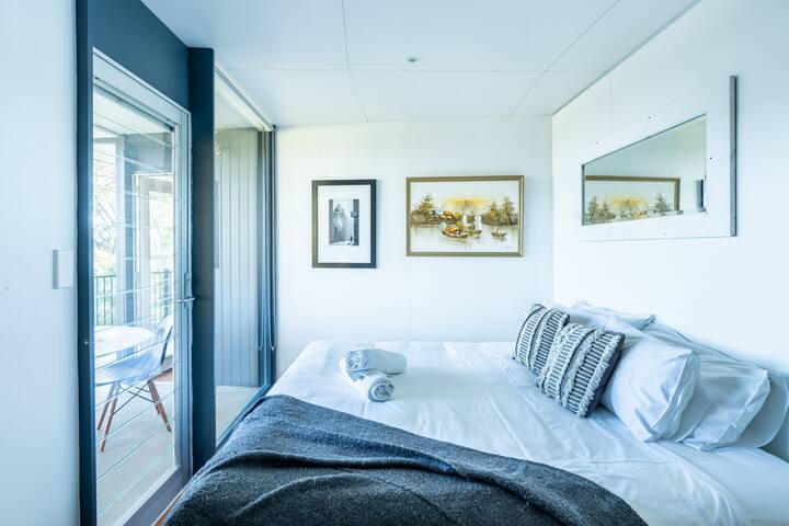 The light-filled second bedroom is set with a sumptuous king and also opens directly to the balcony.
