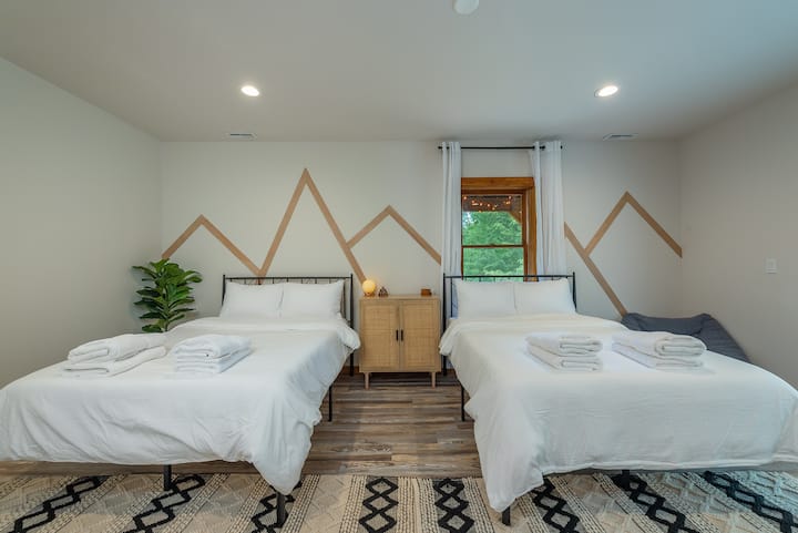The entire ground floor is devoted to the bedroom suite, aside from a laundry area and access to the lower porch.  Luggage racks and a dresser provided.