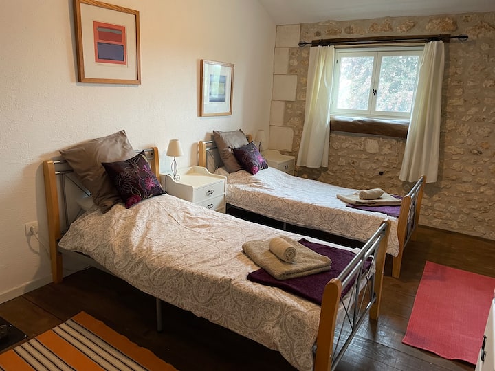 Bedroom 3 with two single beds, wardrobe, bedside lamps, mirror and chest of drawers.