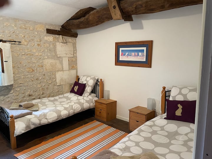 Bedroom 2 - Two single beds  with wardrobe, chest of drawers, bedside cabinets with bedside lamps and a mirror.