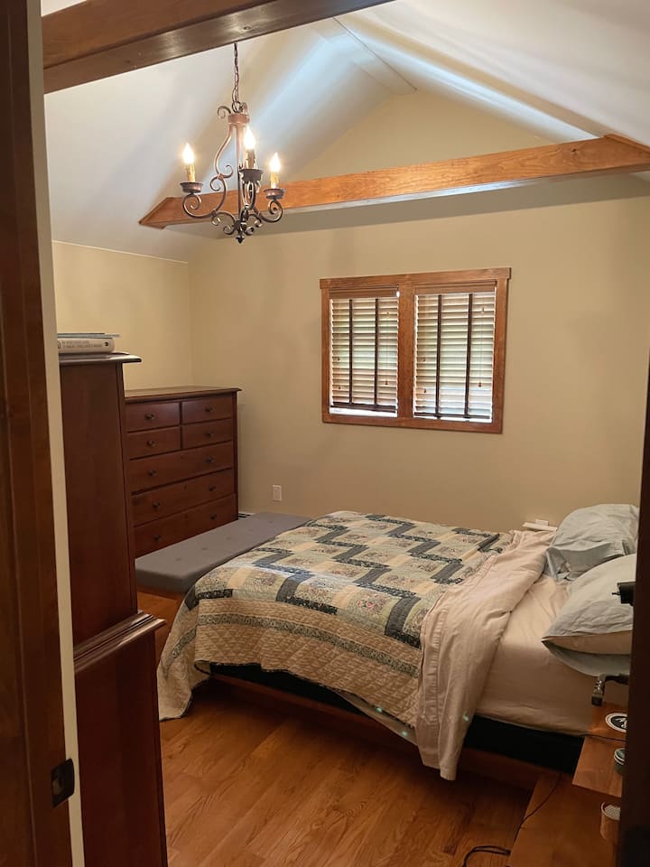 O quarto principal é pequeno, mas tem seu próprio teto de catedral e armário e fica ao lado do banheiro principal. Cama de casal com colchão temperado, cabeceira e mesas de cabeceira em ambos os lados; duas cômodas.
