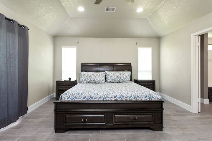 Primary bedroom- king sized bed with cotton blankets and premium linens