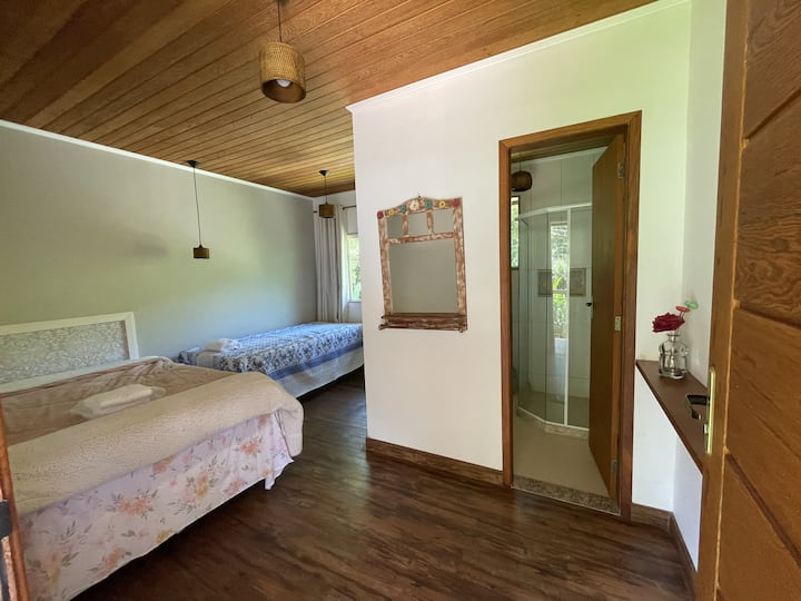 Suite 1, ubicada en el segundo piso de la casa de huéspedes. Nota: en el caso de 15 huéspedes, se agrega una cama baja (a 20 cm del piso) a este espacio entre la puerta y el baño.