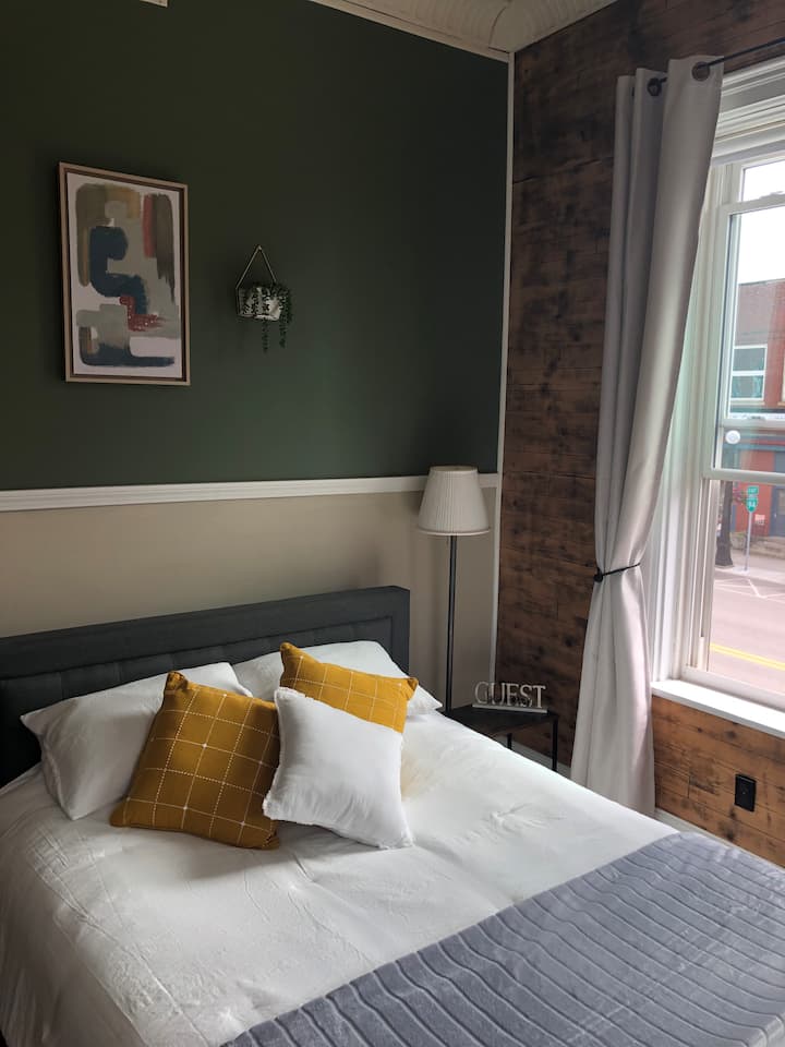 A cozy queen-sized bed with 100% cotton sheets for a comfortable nights sleep