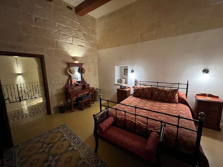 The kingsized bedroom on the first floor. This is an original large bedroom overlooking the pool/garden area of our home.