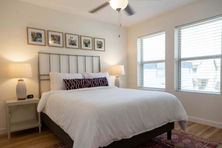Guest bedroom with a queen bed and walk-in closet