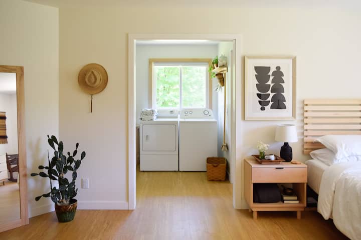 main floor bedroom with washer/dryer and private bath