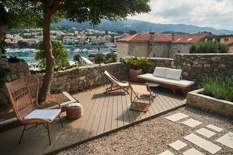 Stone house with a garden within old city walls