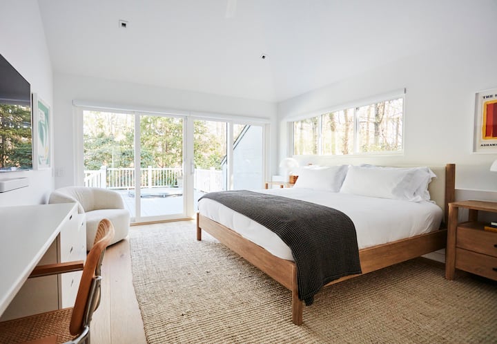 primary bedroom with king bed + sliders to pool/spa and deck. 65 samsung tv + work from home desk with ethernet plug-in.  