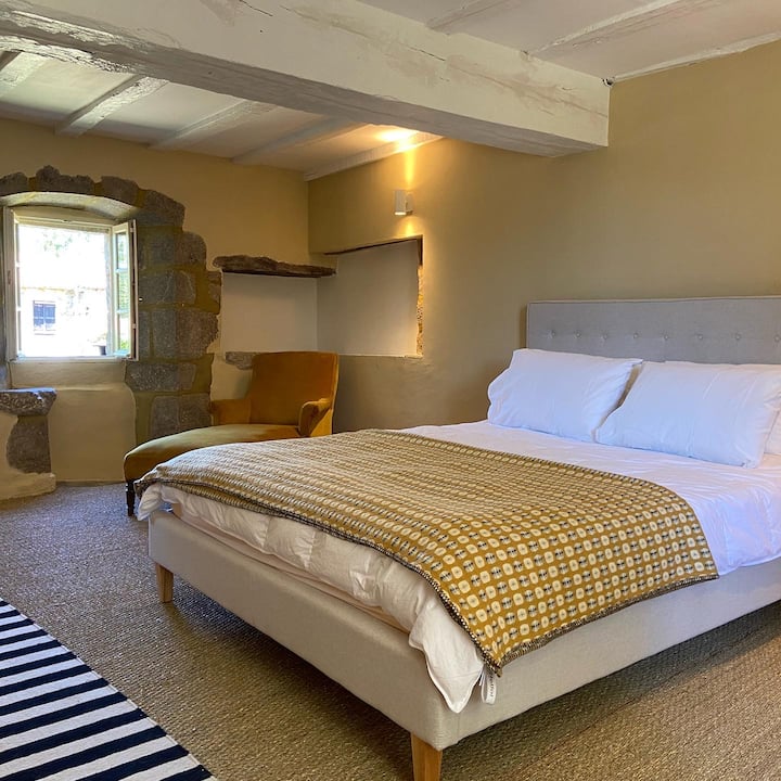 The yellow medieval bedroom has a comfortable king-size bed and views to the front and the rear of Le Parc. The windows have the original stone seating ledges built-in. 