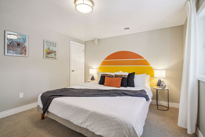 Cal-king bed in the Kings of Leon room. Phone charger outlet built into table lamps. Lower level. 

Work desk inside closet.