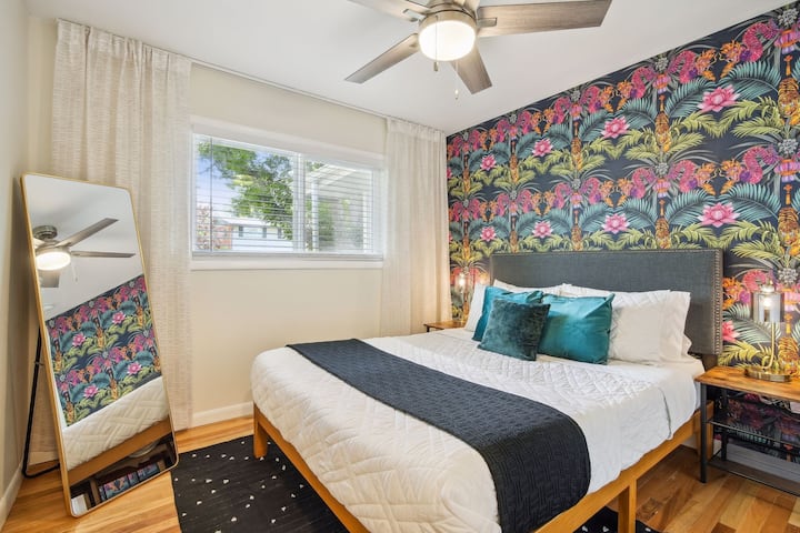 Light and bright queen room also known as the Taylor Swift room. This bed is a tempurpedic. Bedside lamps have charger outlet built in. Main floor. 