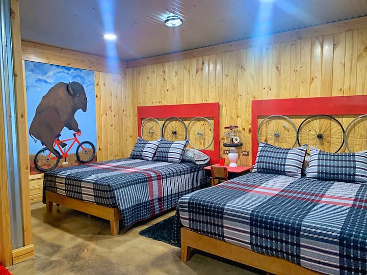 two queen sized beds in the Tour de Bison Cabin at The Lazy Buffalo near the Wichita Mountains