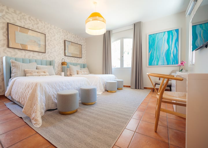 Bedroom 3: Two (2) double beds sits comfortably on this bright, airy room with elegant details and colorful accents set a tone of laid-back Caribbean luxury throughout this vacation rental.