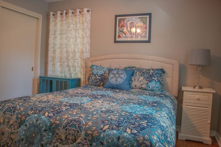 Bedroom with queen size bed. Roku tv