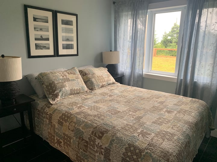 Queen bed located on the first level of the home. All above ground with stunning view. A living room a full piece bath is also located on this level. 