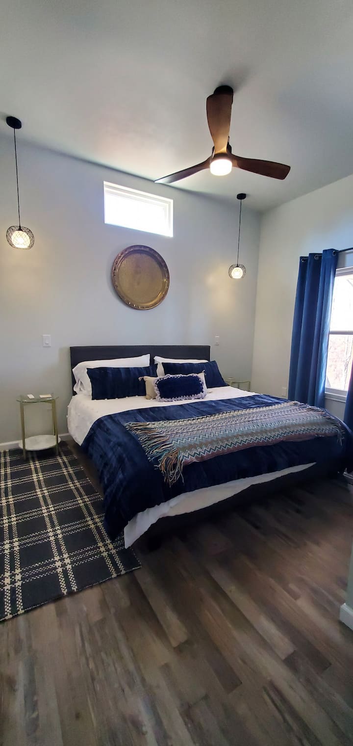 Cama tamaño king con mantas eléctricas durante el invierno y cargadores de teléfono en las mesas nocturnas para tu comodidad