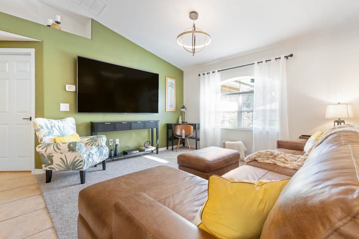 You can see the new 85 inch flat-screen television, desk for working and palm chair for reading.  From this room, you will enjoy views of the front yard and plants 