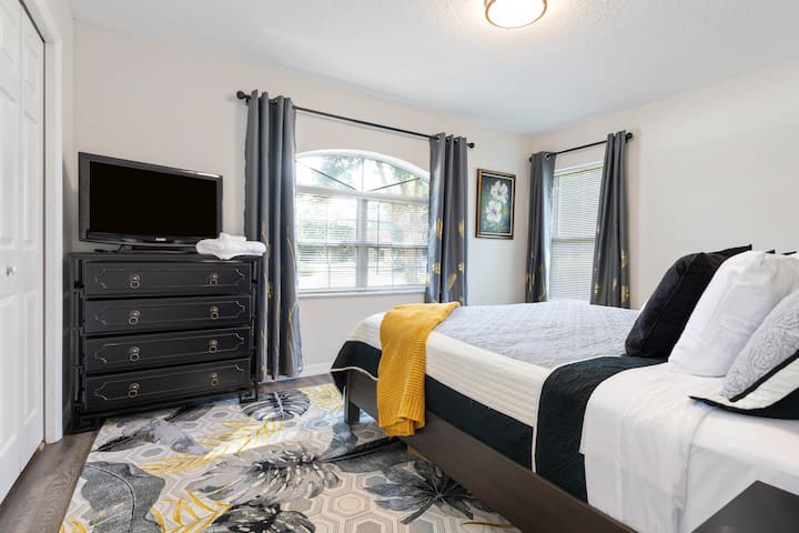 Well appointed 2nd bedroom with King bed, flat screen tv setup for streaming with views into the front yard.  