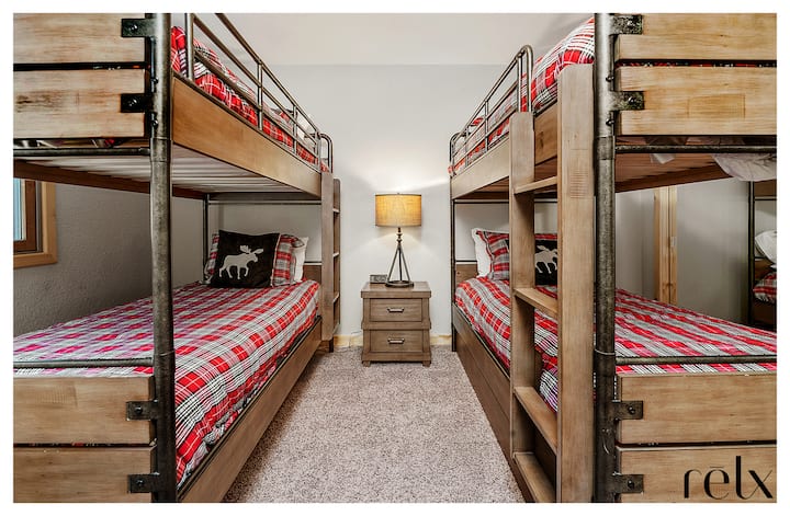 Our kid room / AKA Cub Den / AKA slumber party room is located upstairs between the primary and secondary bedrooms.  Two sets of bunk beds with a total of four single beds. 